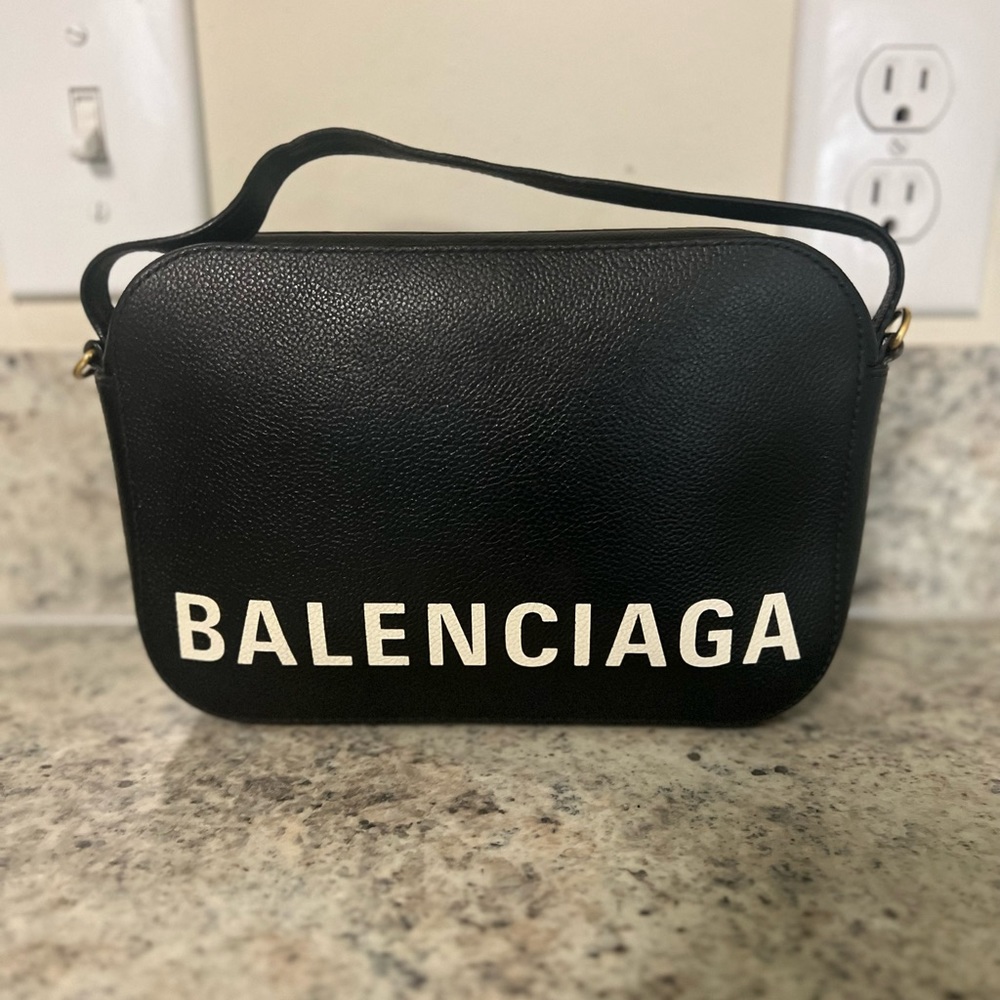 Stylist top handle crossbody bag.